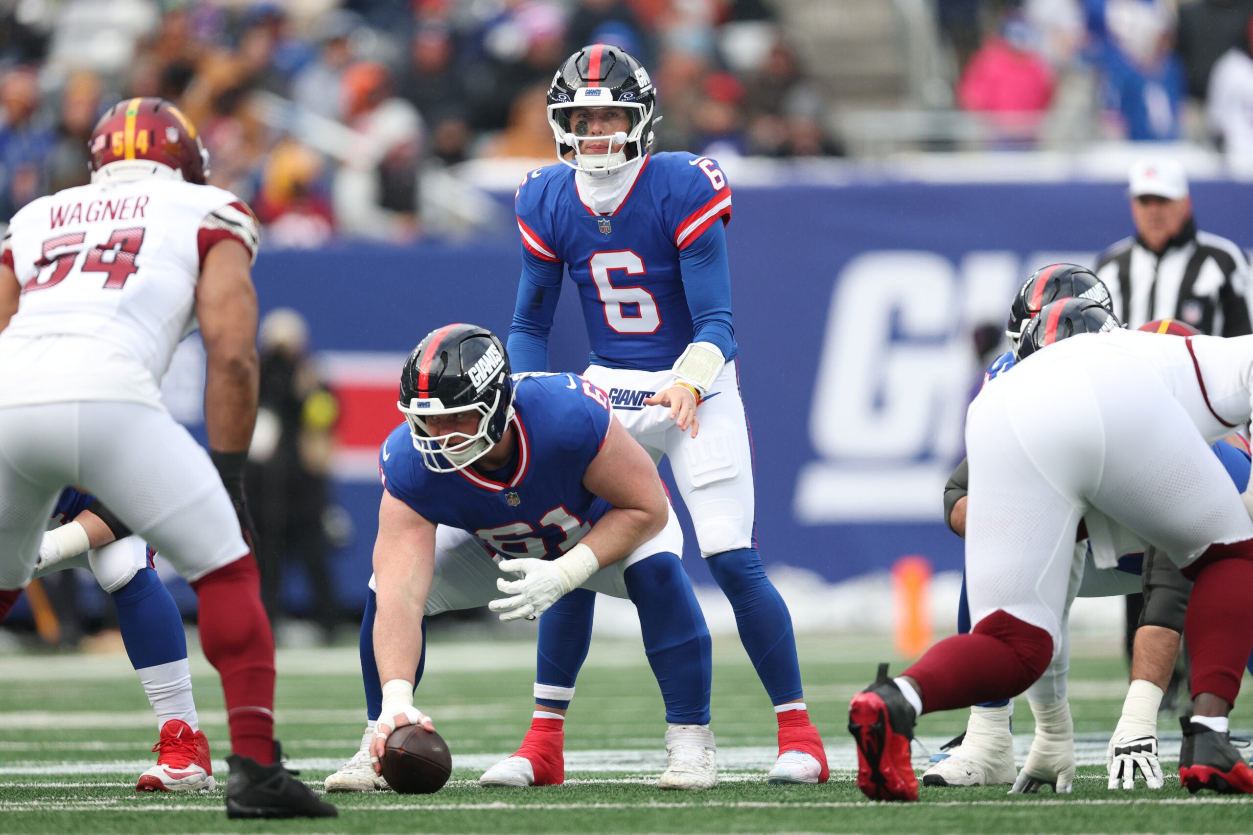 Dec 14, 2025; East Rutherford, New Jersey, USA; New York Giants quarterback Jaxson Dart (6) awaits the snap from center John Michael Schmitz Jr. (61) during the first quarter against the Washington Commanders at MetLife Stadium.