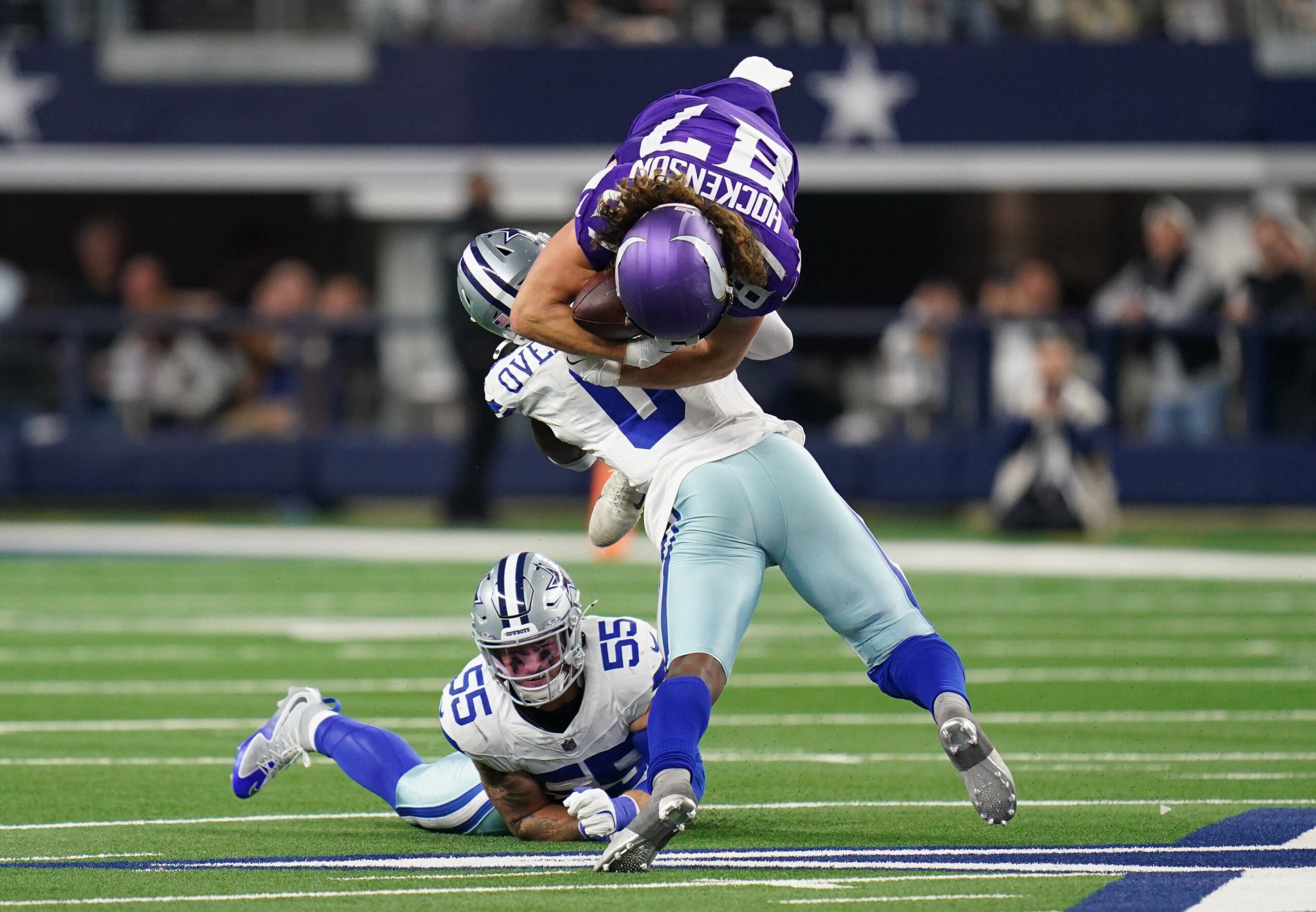 Dec 14, 2025; Arlington, Texas, USA; Minnesota Vikings tight end T.J. Hockenson (87) is tackled by Dallas Cowboys linebacker Demarvion Overshown (0) during the second half at AT&T Stadium.