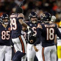 Chicago Bears quarterback Caleb Williams (18) is swarmed by teammates after throwing the game-winning touchdown pass in overtime against the Green Bay Packers during their football game Saturday, December 20, 2025, at Soldier Field in Chicago, Illinois.