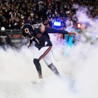 Dec 20, 2025; Chicago, Illinois, USA; Chicago Bears cornerback Jaylon Johnson (1) runs onto the field during player introductions before the game against the Green Bay Packers at Soldier Field.