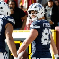 Dec 25, 2025; Landover, Maryland, USA; Dallas Cowboys tight end Jake Ferguson (87) celebrates after scoring a touchdown against the Washington Commanders in the first quarter at Northwest Stadium.