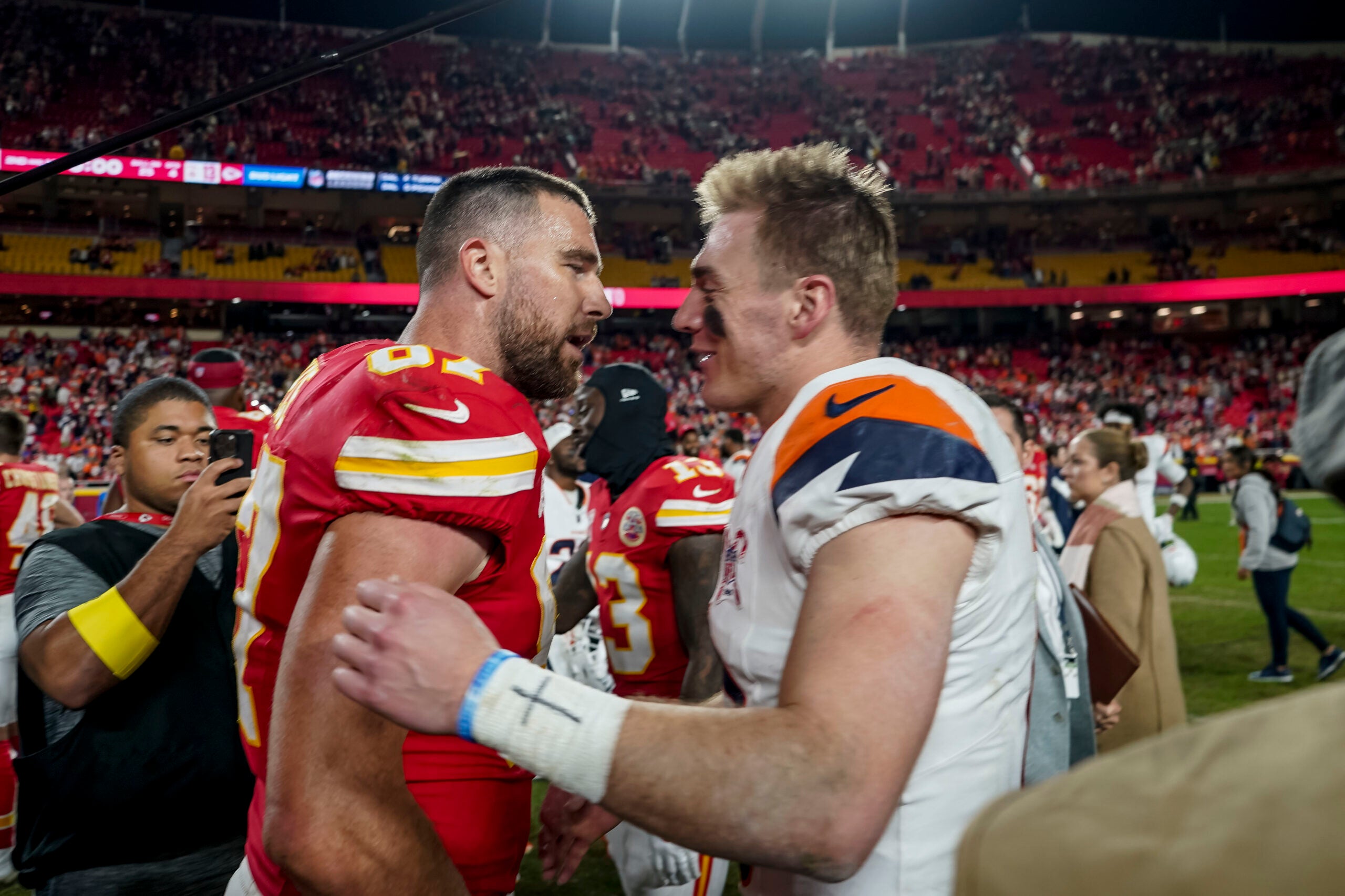 Dec 25, 2025; Kansas City, Missouri, USA; Denver Broncos quarterback Bo Nix (10) and Kansas City Chiefs tight end Travis Kelce (87) after the game at GEHA Field at Arrowhead Stadium.