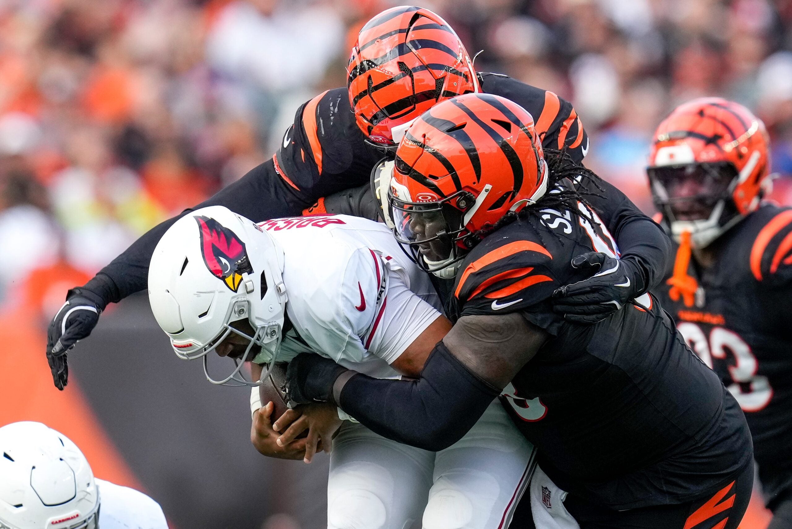 Cincinnati Bengals defensive tackle T.J. Slaton Jr. (98) pulls down Arizona Cardinals quarterback Jacoby Brissett (7) in the third quarter of the NFL Week 17 game between the Cincinnati Bengals and the Arizona Cardinals at Paycor Stadium in Downtown Cincinnati on Sunday, Dec. 28, 2025. The Bengals won 37-14.
