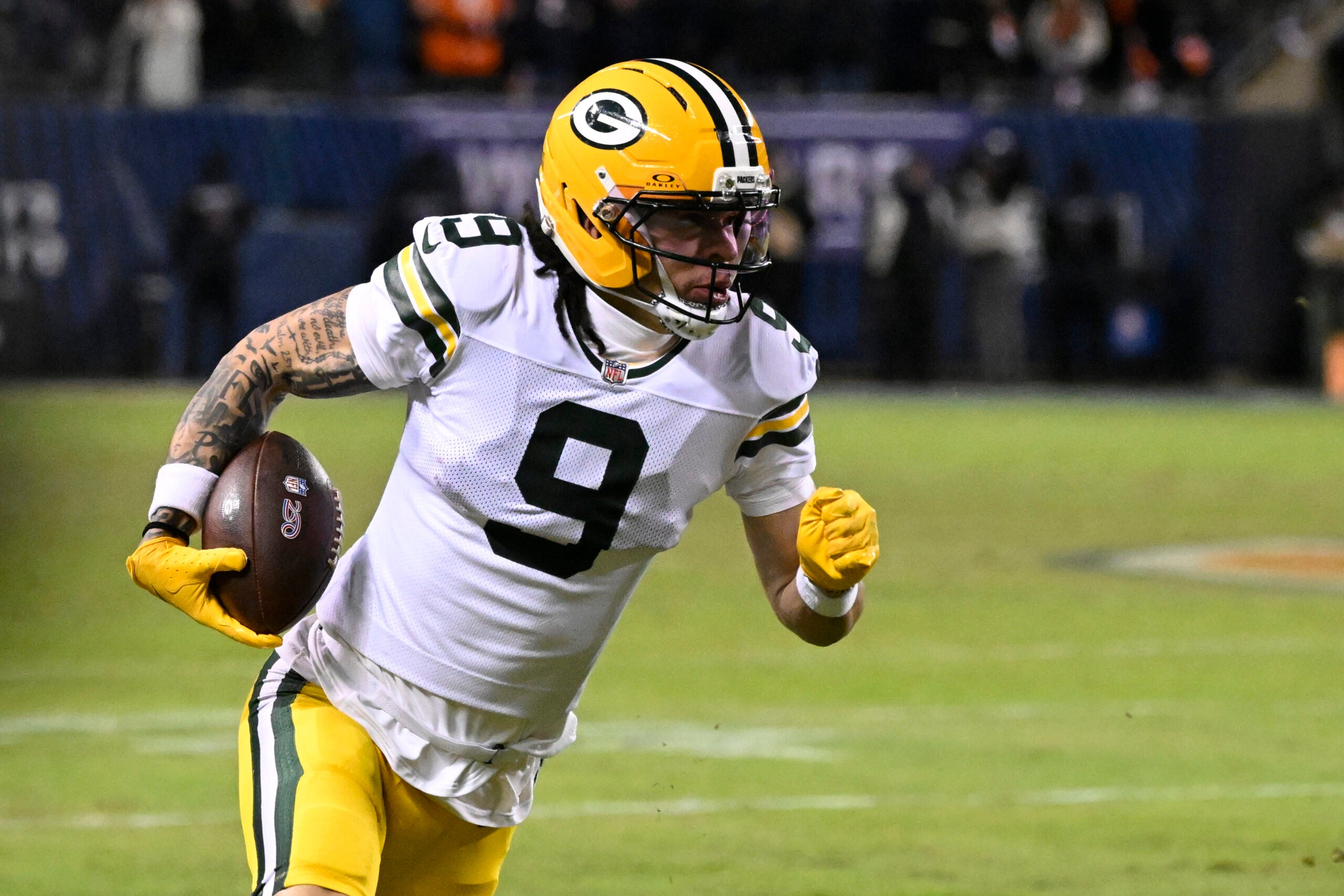 Jan 10, 2026; Chicago, IL, USA; Green Bay Packers wide receiver Christian Watson (9) runs after the catch against the Chicago Bears during the first half of an NFC Wild Card Round game at Soldier Field.