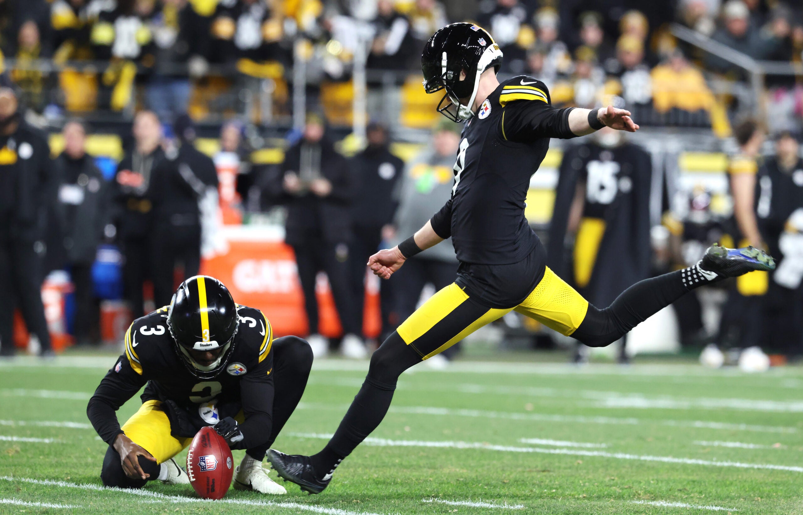 Jan 12, 2026; Pittsburgh, PA, USA; Pittsburgh Steelers place kicker Chris Boswell (9) kicks a field goal out of the hold by punter Corliss Waitman (3) during the first half of an AFC Wild Card Round game against the Houston Texans at Acrisure Stadium.