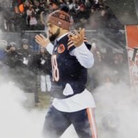 Jan 18, 2026; Chicago, IL, USA; Chicago Bears quarterback Caleb Williams (18) runs onto the field during player introductions before an NFC Divisional Round game against the Los Angeles Rams at Soldier Field.