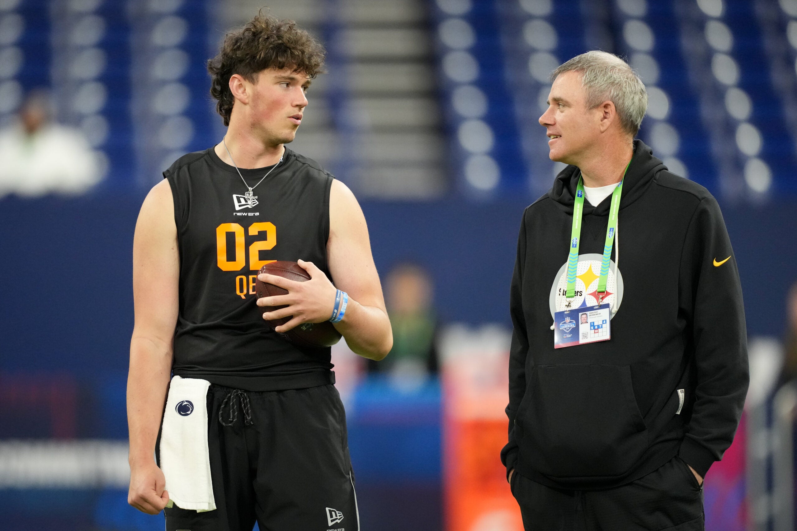 Feb 28, 2026; Indianapolis, IN, USA; Penn State quarterback Drew Allar (QB02) speaks with Pittsburgh Steelers quarterbacks coach Tim Berbenich during the NFL Scouting Combine at Lucas Oil Stadium.