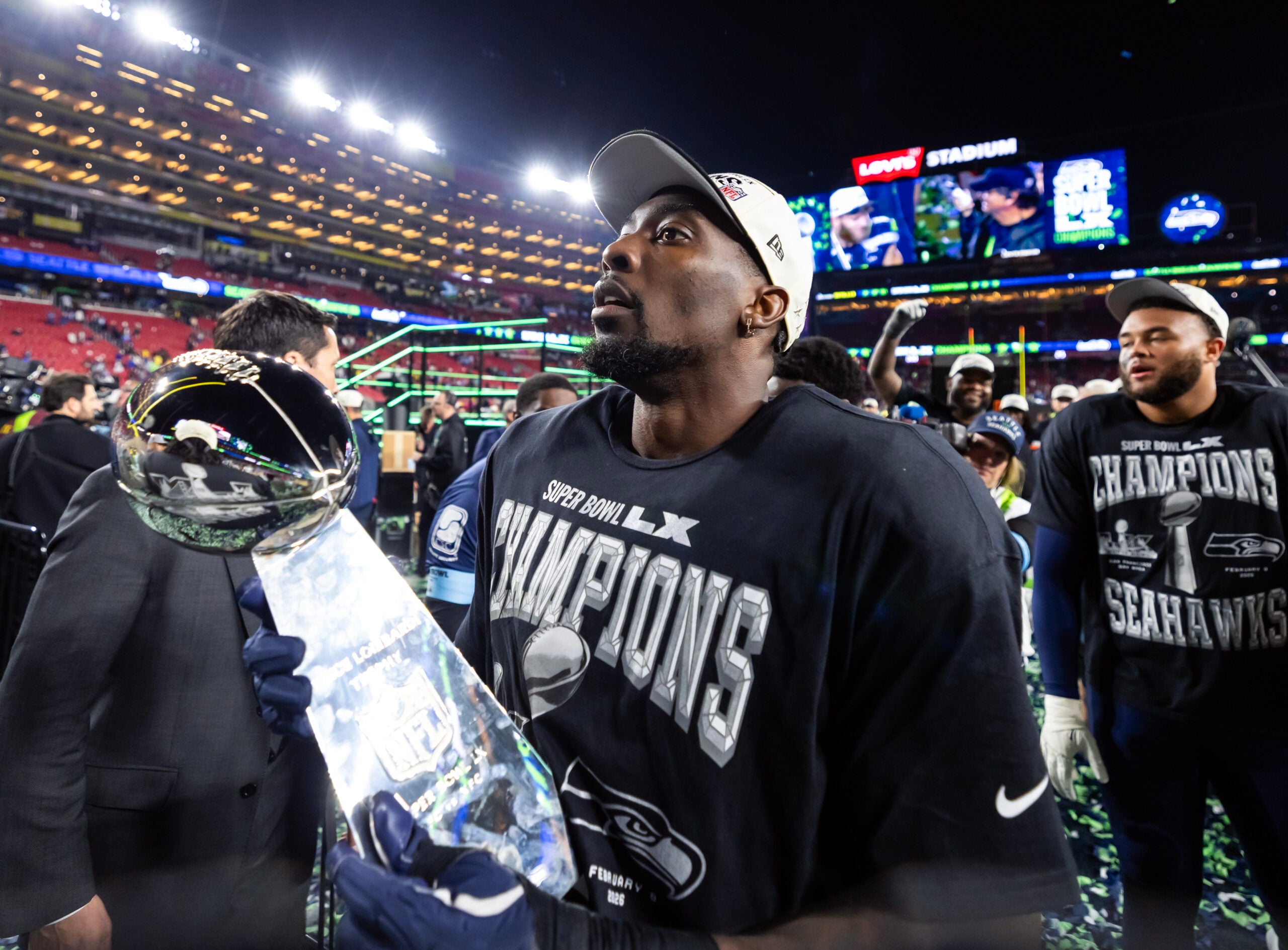 Feb 8, 2026; Santa Clara, CA, USA; Seattle Seahawks defensive end DeMarcus Lawrence (0) celebrates with the Vince Lombardi Trophy after defeating the New England Patriots during Super Bowl LX at Levi's Stadium.