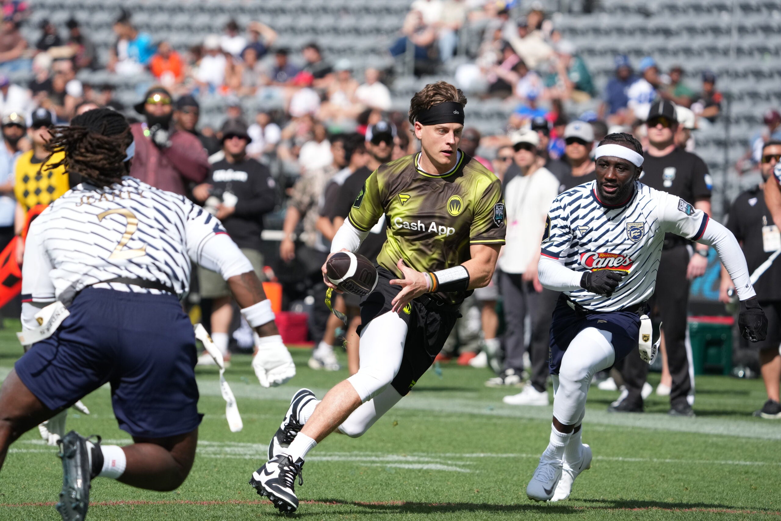 Mar 21, 2026; Los Angeles, CA, USA; Wildcats FFC quarterback Joe Burrow carries the ball against Ashton Jeanty of Founders FFC during the Fanatics Flag Football Classic at BMO stadium.