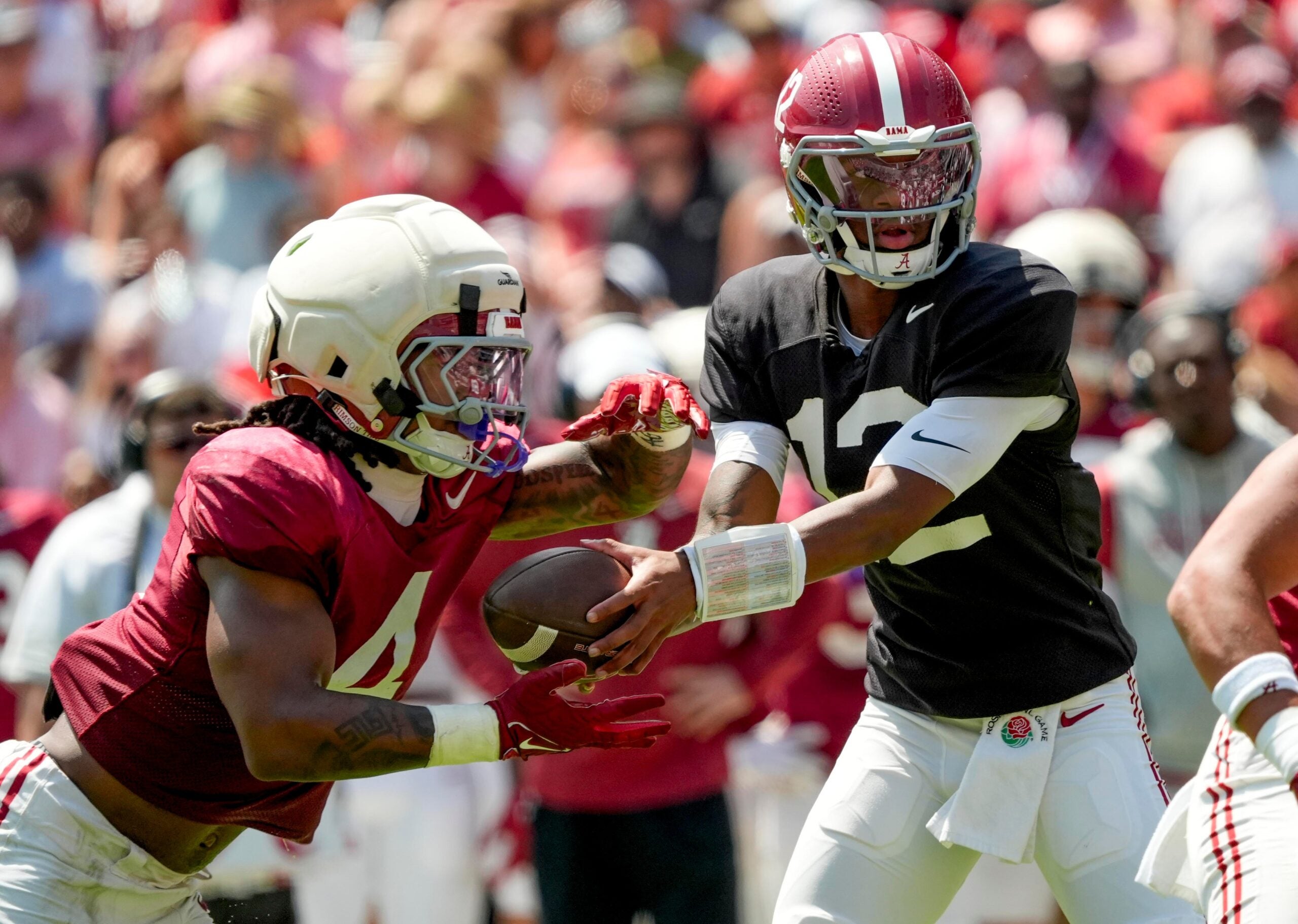April 11, 2026; Tuscaloosa, AL, USA; Alabama quarterback Keelon Russell hands off to running back Daniel Hill at Bryant-Denny Stadium during the Alabama A Day scrimmage.