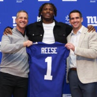 Apr 24, 2026; East Rutherford, NJ, USA; New York Giants draft pick Arvell Reese, Head Coach John Harbaugh (left) and General Manager Joe Schoen (right) pose for a photo during the introductory press conference at Quest Diagnostics Training Center.