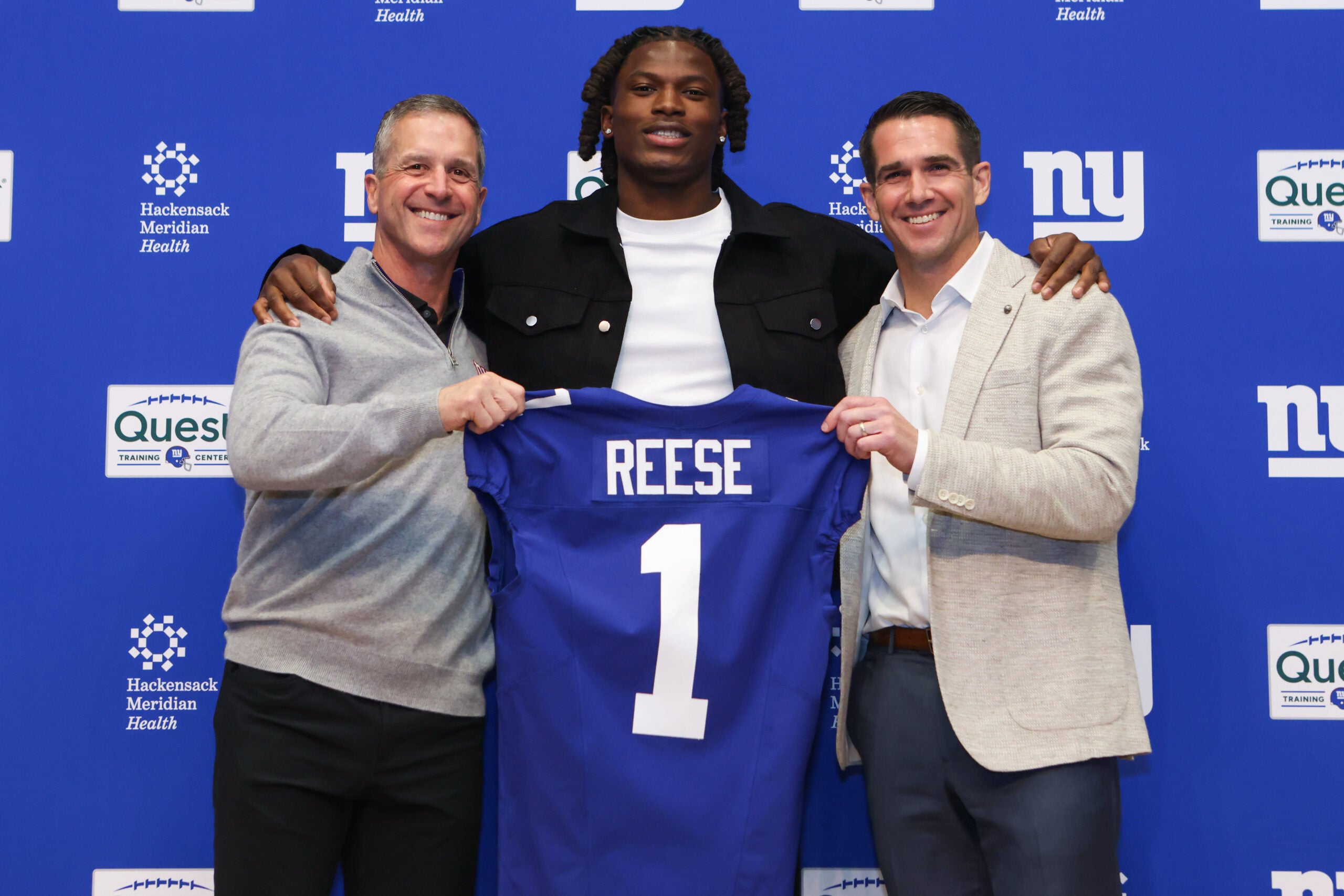 Apr 24, 2026; East Rutherford, NJ, USA; New York Giants draft pick Arvell Reese, Head Coach John Harbaugh (left) and General Manager Joe Schoen (right) pose for a photo during the introductory press conference at Quest Diagnostics Training Center.