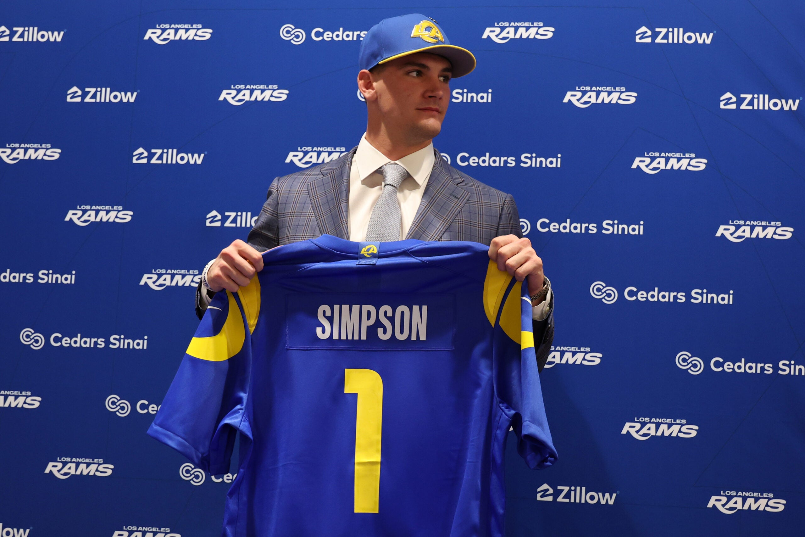 Apr 24, 2026; Inglewood, CA, USA; Los Angeles Rams first-round draft pick Ty Simpson poses with his jersey during a press conference at Code Next at Hollywood Park.
