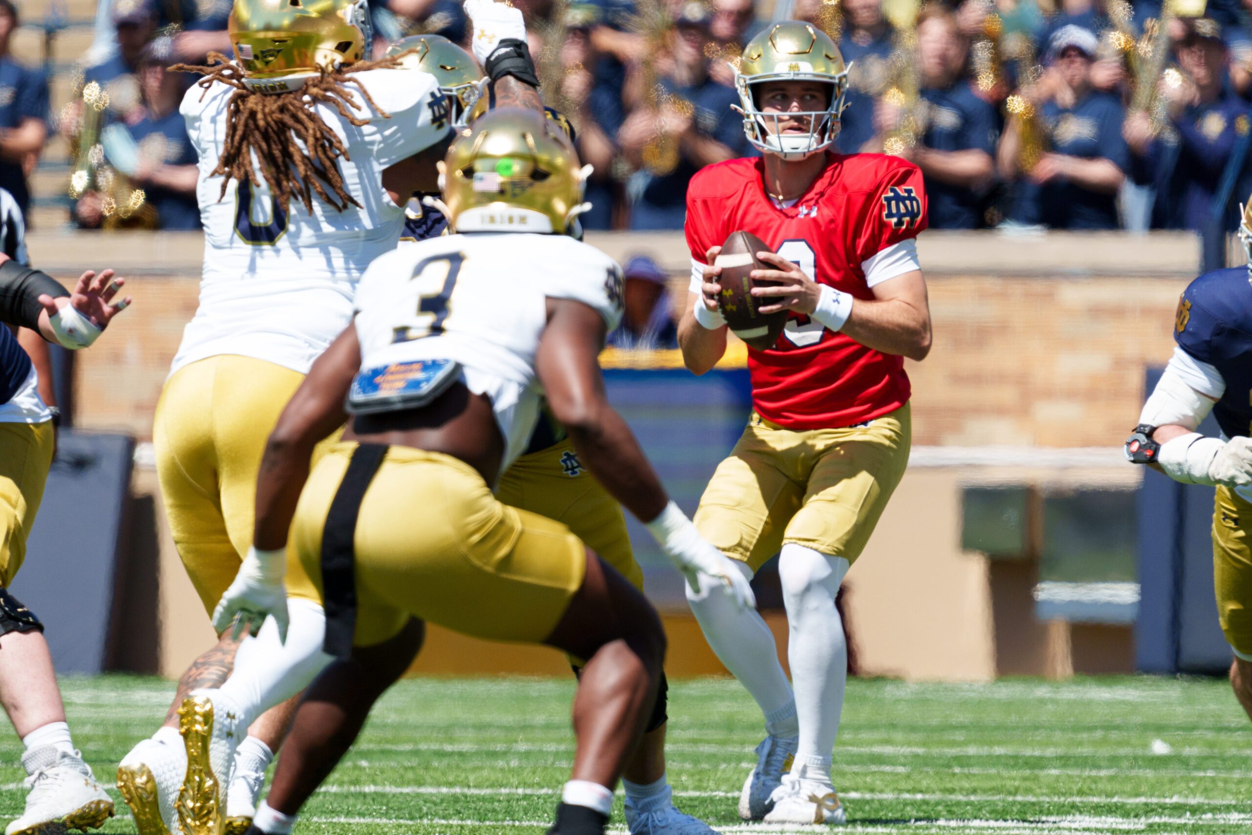Notre Dame quarterback CJ Carr, right, looks for a teammate to pass to during the Blue-Gold spring game at Notre Dame Stadium on Saturday, April 25, 2026, in South Bend.