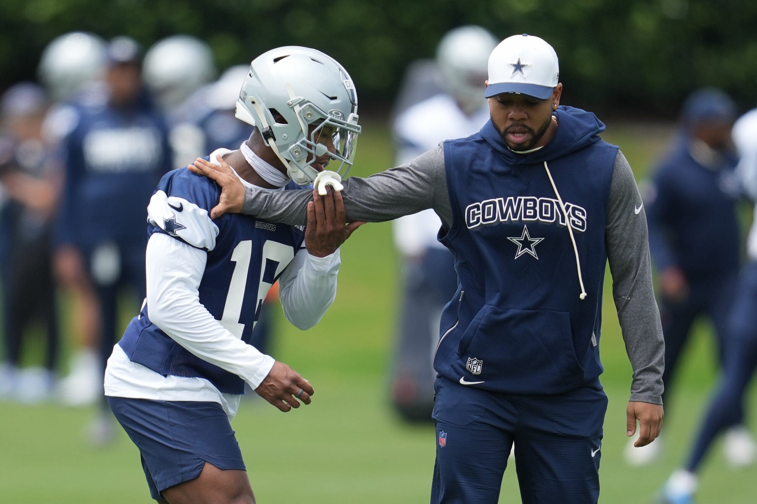 May 1, 2026; Frisco, TX, USA; Dallas Cowboys cornerback Caleb Downs (18) is coached through a drill with defensive coordinator Christian Parker at the Ford Center at the Star Training Facility in Frisco, Texas.