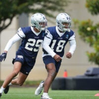 May 1, 2026; Frisco, TX, USA; Dallas Cowboys cornerback Devin Moore (29) and Dallas Cowboys safety Caleb Downs (18) go through a drill during practice at the Ford Center at the Star Training Facility in Frisco, Texas.