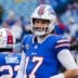Buffalo Bills quarterback Josh Allen (17) smiles at something someone said before the Buffalo Bills wild card game against the Denver Broncos at Highmark Stadium in Orchard Park on Jan. 12, 2025.