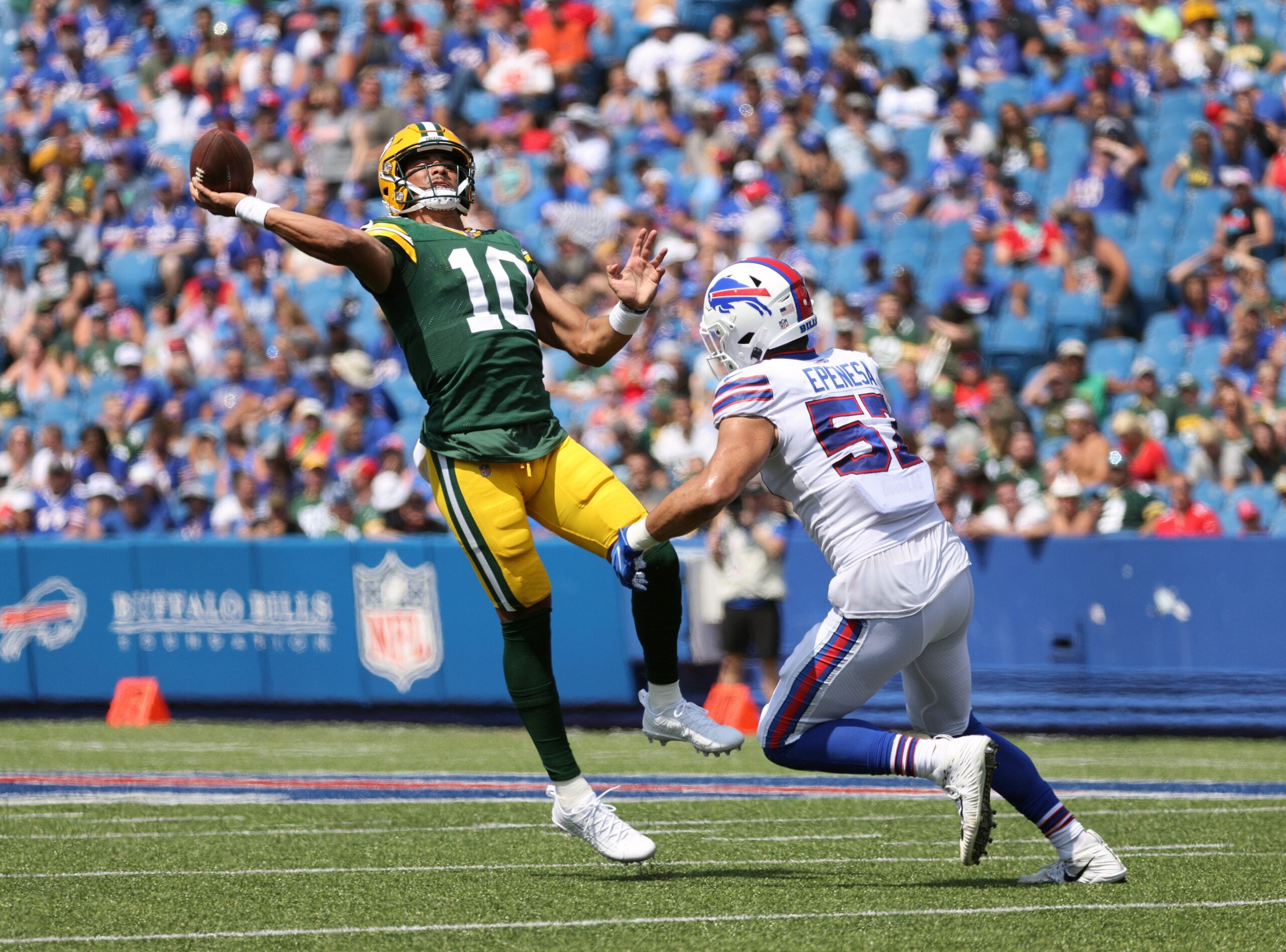 Packers quarterback Jordan Love tries to throw the ball away as he is pressured by Bills A.J. Epenesa. The pass was intercepted n the end zone by Micah Hyde.