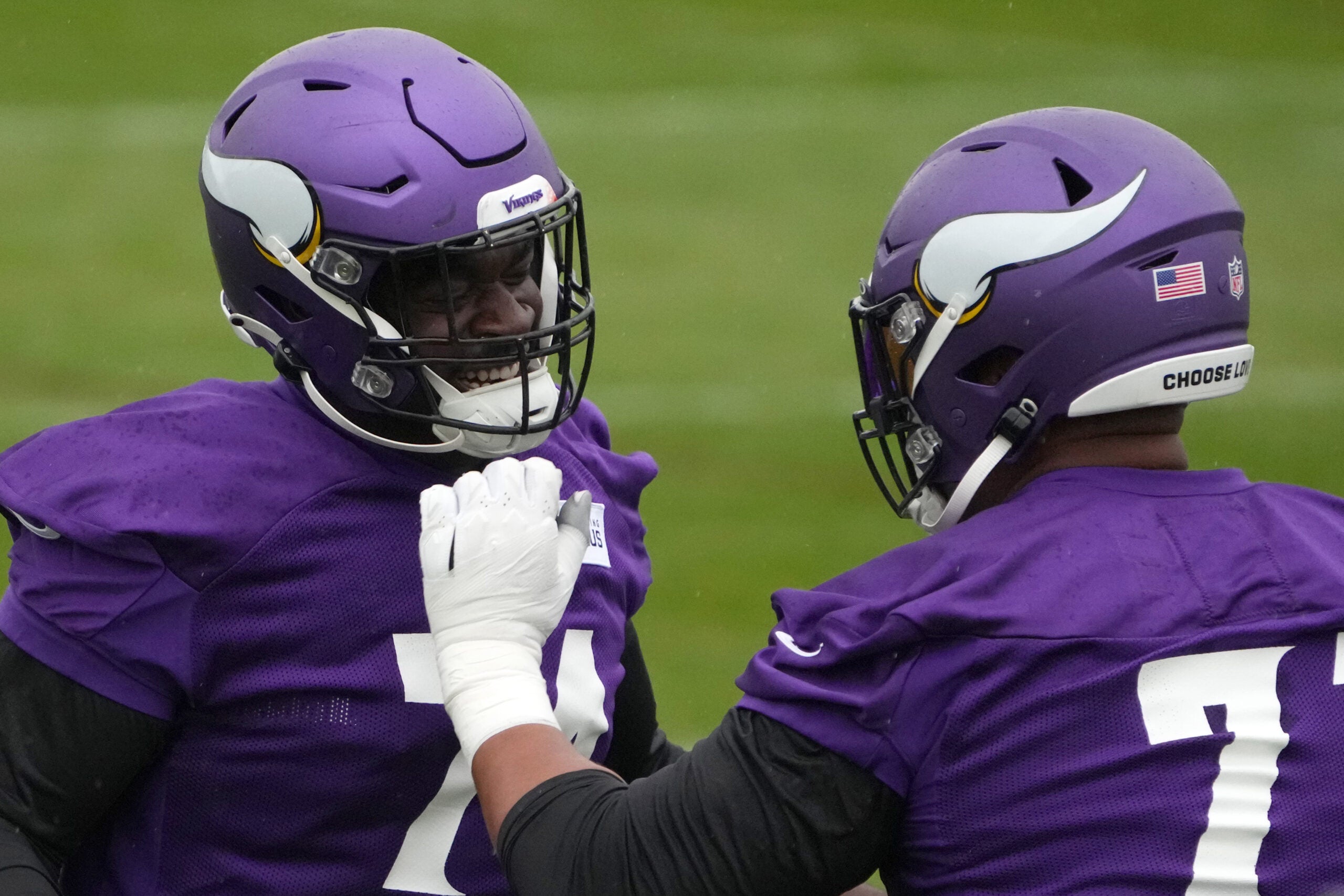 Sep 30, 2022; Thundridge, United Kingdom; Minnesota Vikings guard Olisaemeka Udoh (74) and offensive tackle Christian Darrisaw (71) partipate in drills during practice at Hanbury Manor.