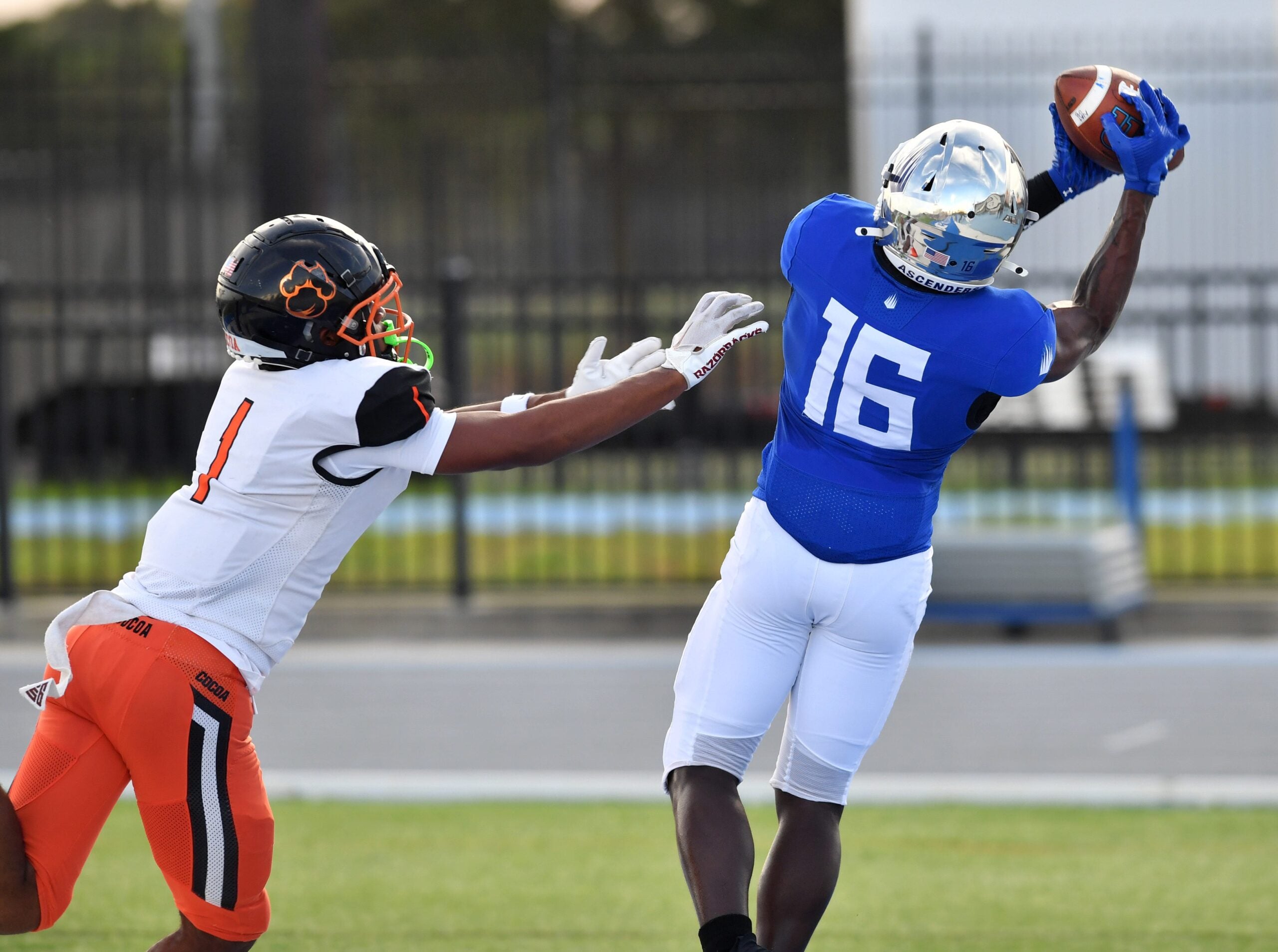 IMG Academy wide receiver Eric McFarland (#16) pulls in a pass in the end zone over Cocoa High free safety CJ Hester (#1) in the first quarter. The IMG Academy National squad hosted the Cocoa High School Tigers Friday, Sept. 6, 2024 in Bradenton.