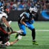 Dec 1, 2024; Charlotte, North Carolina, USA; Carolina Panthers running back Jonathon Brooks (24) runs as Tampa Bay Buccaneers cornerback Zyon McCollum (27) defends in the third quarter at Bank of America Stadium.