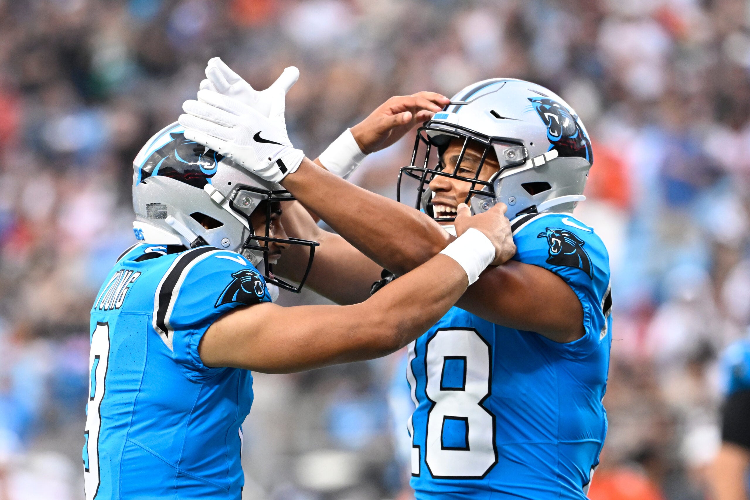 Aug 8, 2025; Charlotte, North Carolina, USA; Carolina Panthers wide receiver Jalen Coker (18) celebrates with quarterback Bryce Young (9) after a touchdown catch in the first quarter at Bank of America Stadium.