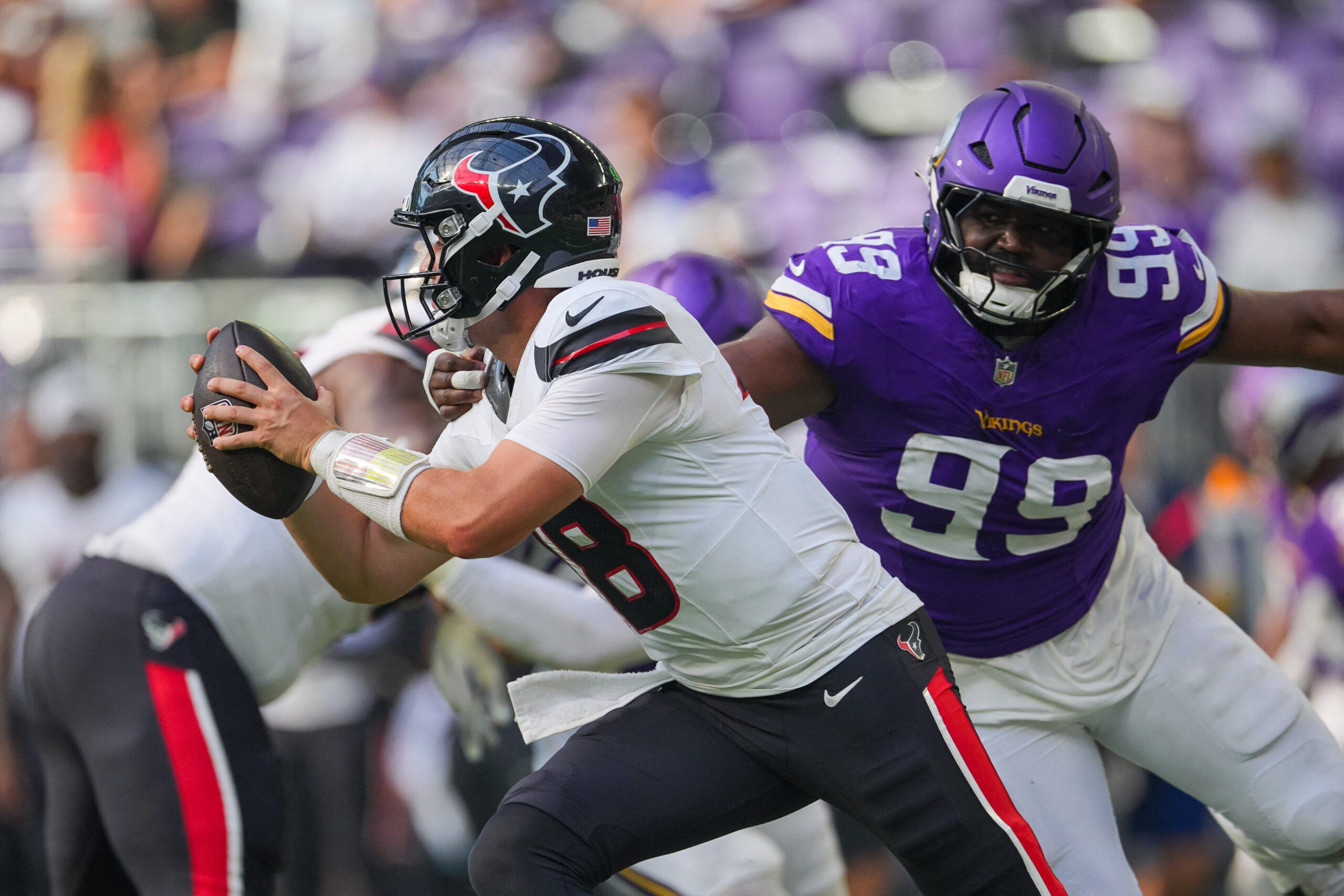 Aug 9, 2025; Minneapolis, Minnesota, USA; Houston Texans wide receiver John Metchie III (8) evades Minnesota Vikings defensive end Elijah Williams (99) in the fourth quarter at U.S. Bank Stadium.