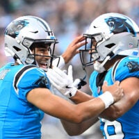 Aug 8, 2025; Charlotte, North Carolina, USA; Carolina Panthers wide receiver Jalen Coker (18) celebrates with quarterback Bryce Young (9) after a touchdown catch in the first quarter at Bank of America Stadium.