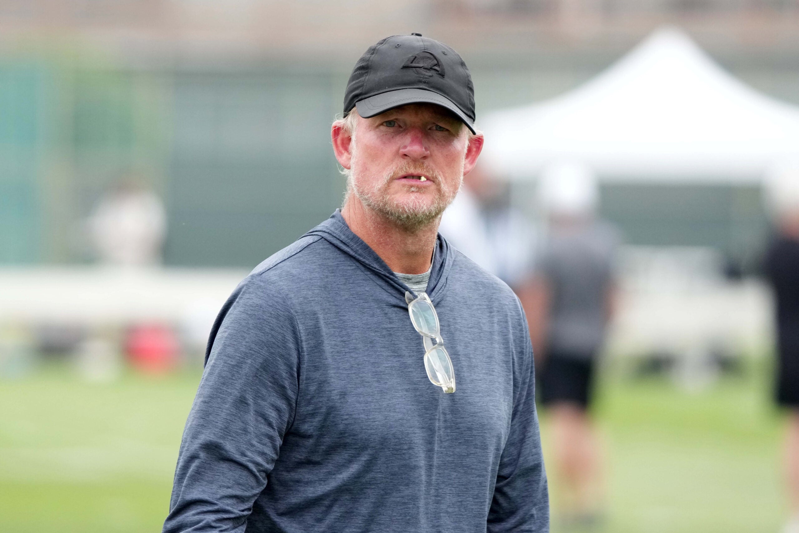 Aug 14, 2025; Carson, CA, USA; Los Angeles Rams general manager Les Snead watches during a joint practice against the New Orleans Saints at the Dignity Health Sports Park.