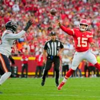 Aug 22, 2025; Kansas City, Missouri, USA; Kansas City Chiefs quarterback Patrick Mahomes (15) throws a pass against Chicago Bears defensive end Dayo Odeyingbo (55) during the first half at GEHA Field at Arrowhead Stadium.