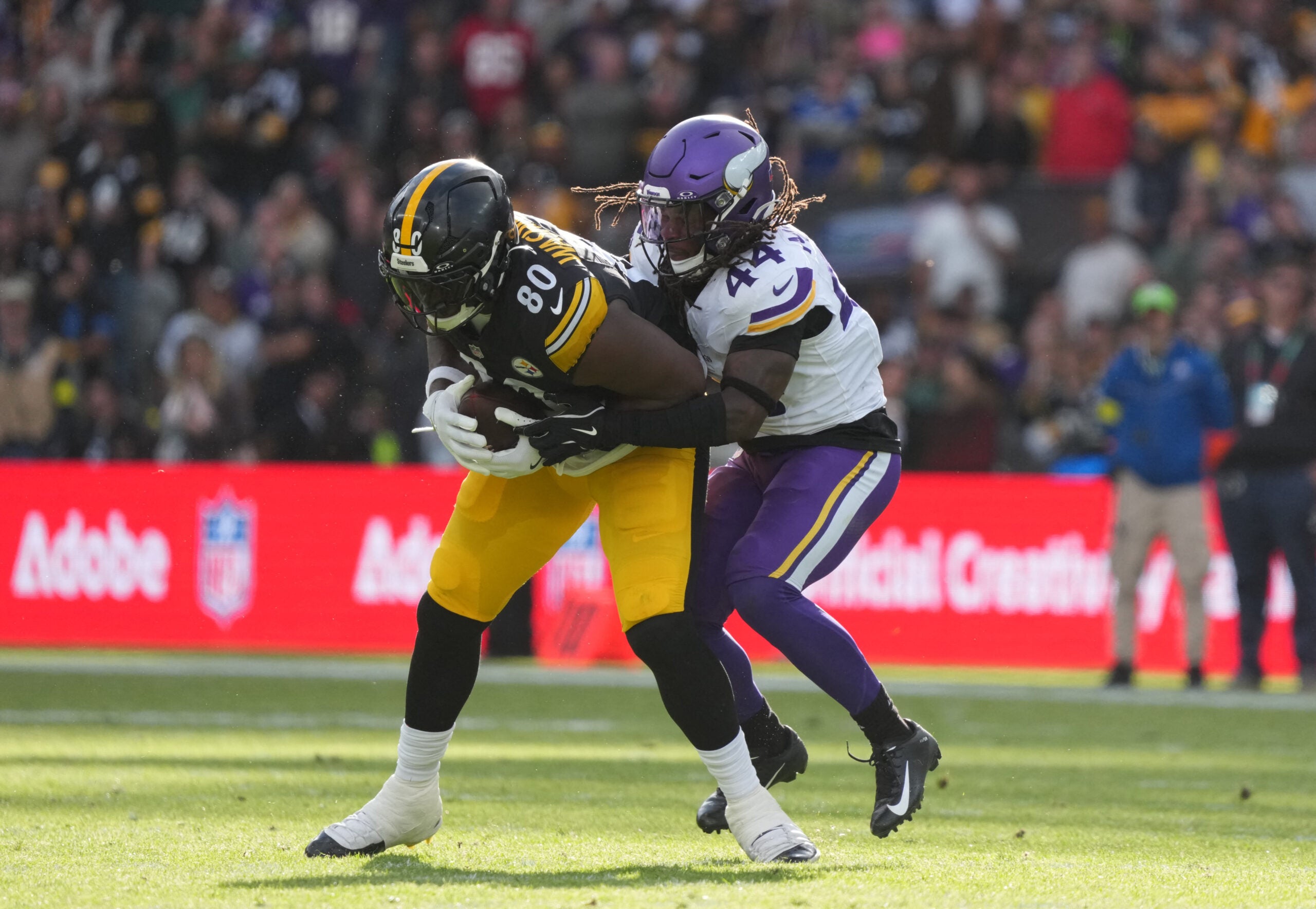 Sep 28, 2025; Dublin, Ireland; Minnesota Vikings safety Josh Metellus (44) tackles Pittsburgh Steelers tight end Darnell Washington (80) during the third quarter during an NFL International Series game at Croke Park.