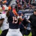 Oct 19, 2025; Chicago, Illinois, USA; Chicago Bears wide receiver Rome Odunze (15) and New Orleans Saints head coach Kellen Moore react after a Chicago first down during the first half at Soldier Field.