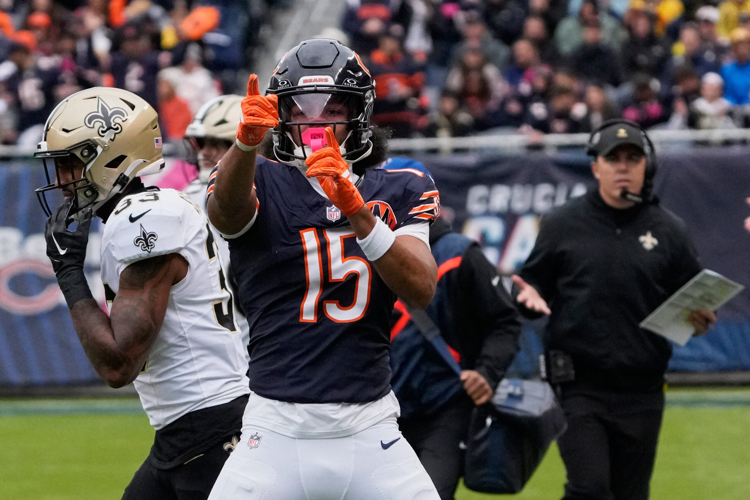 Oct 19, 2025; Chicago, Illinois, USA; Chicago Bears wide receiver Rome Odunze (15) and New Orleans Saints head coach Kellen Moore react after a Chicago first down during the first half at Soldier Field.