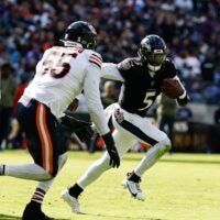Oct 26, 2025; Baltimore, Maryland, USA; Baltimore Ravens quarterback Tyler Huntley (5) runs with the ball as Chicago Bears defensive end Dayo Odeyingbo (55) chases in the third quarter at M&T Bank Stadium.