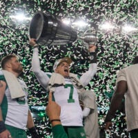 Nov 16, 2025; Winnipeg, Manitoba, Canada; Saskatchewan Roughriders quarterback Trevor Harris (7) lifts the Grey Cup in celebration of the win against the Montreal Alouettes during the 112th Grey Cup Championship at Princess Auto Stadium.