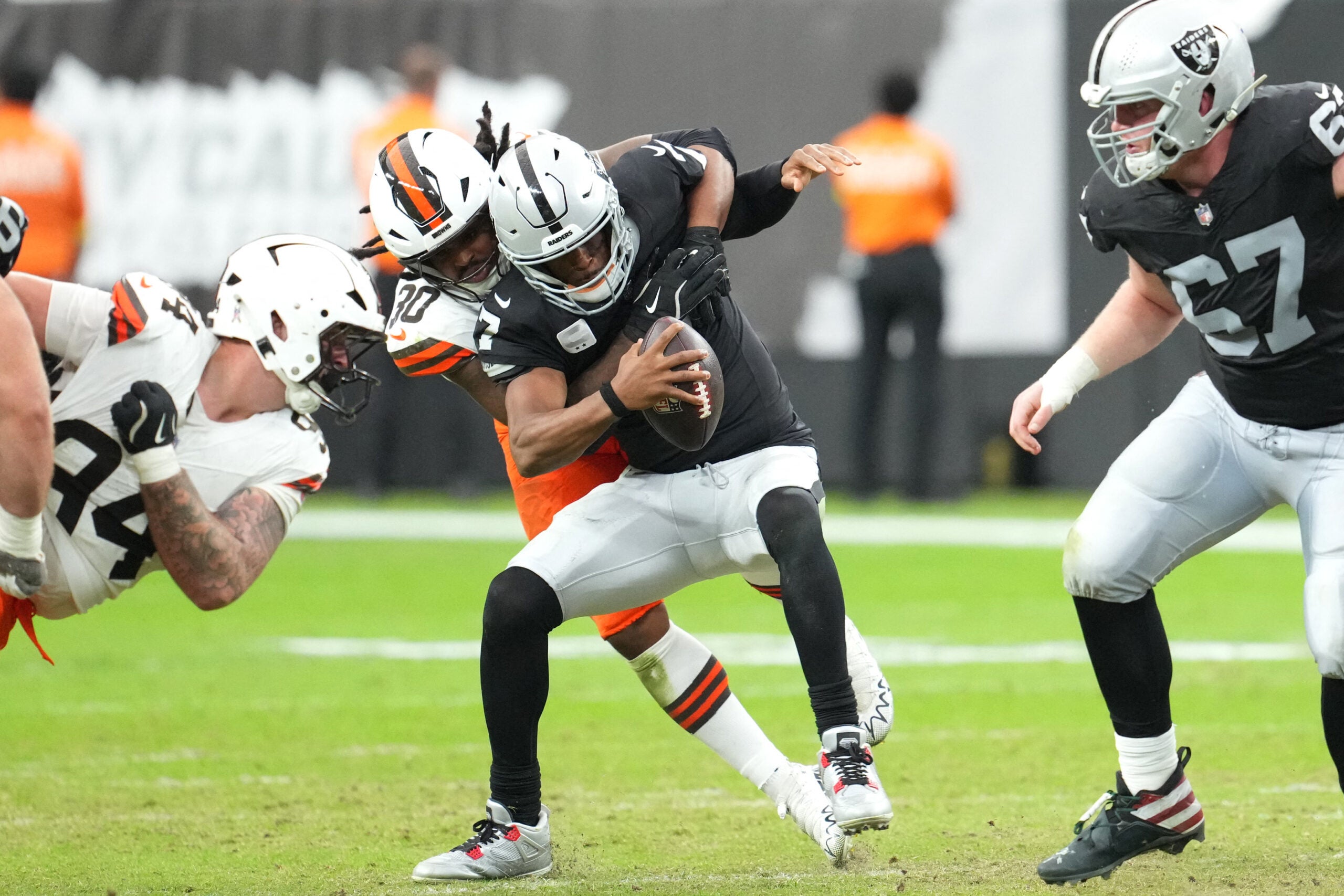 Nov 23, 2025; Paradise, Nevada, USA; Cleveland Browns linebacker Devin Bush (30) sacks Las Vegas Raiders quarterback Geno Smith (7) in the first half at Allegiant Stadium.