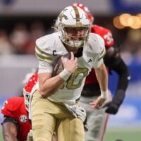 Nov 28, 2025; Atlanta, Georgia, USA; Georgia Tech Yellow Jackets quarterback Haynes King (10) runs the ball against the Georgia Bulldogs in the first quarter at Mercedes-Benz Stadium.