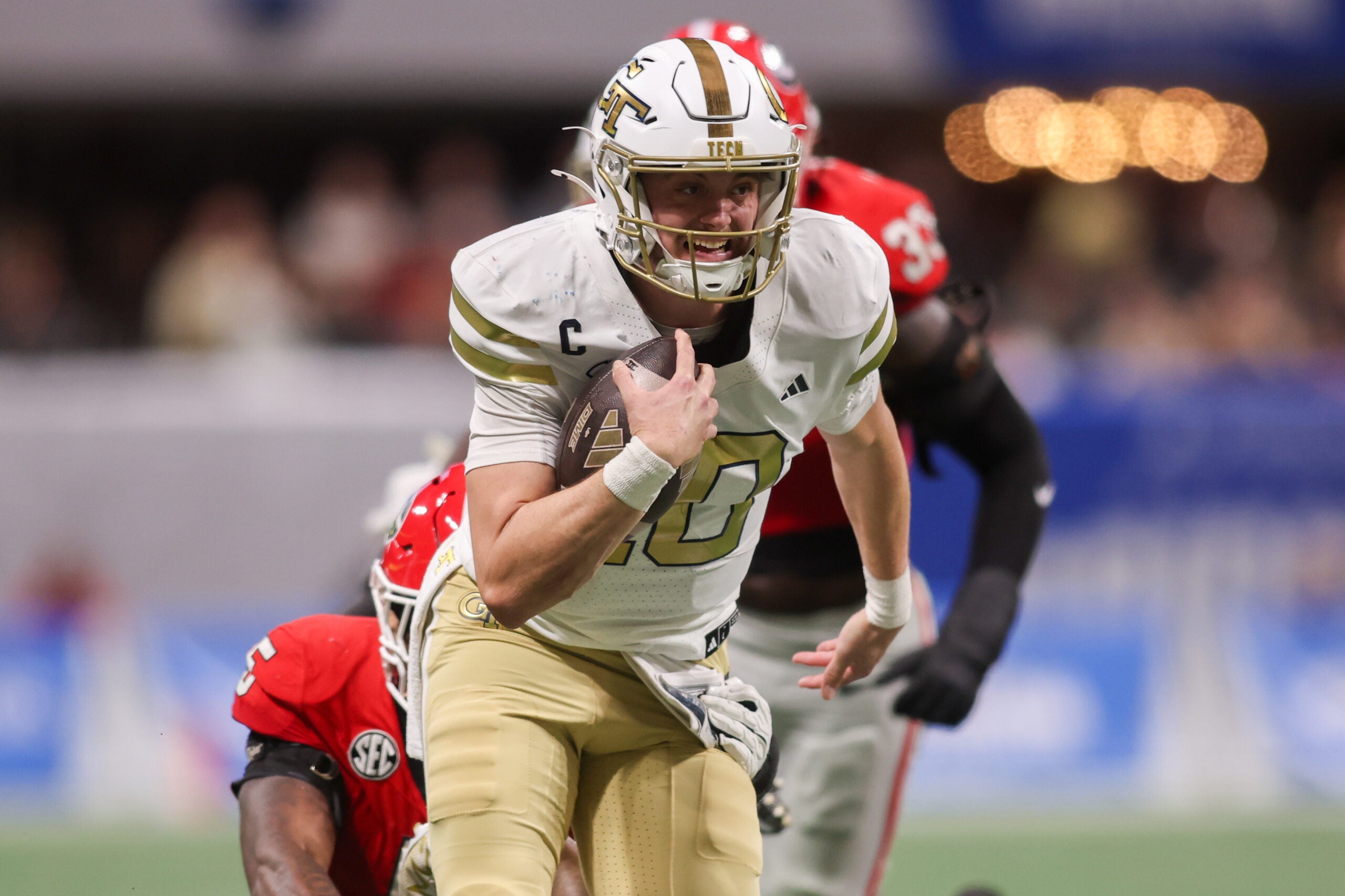 Nov 28, 2025; Atlanta, Georgia, USA; Georgia Tech Yellow Jackets quarterback Haynes King (10) runs the ball against the Georgia Bulldogs in the first quarter at Mercedes-Benz Stadium.