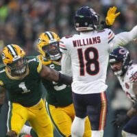 Green Bay Packers defensive end Micah Parsons (1) and defensive end Rashan Gary (52) pressure Chicago Bears quarterback Caleb Williams.