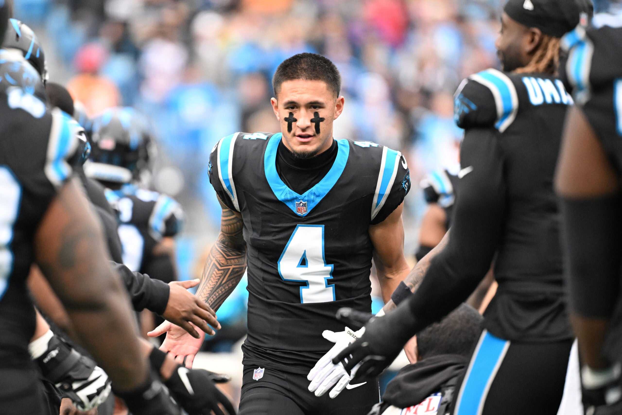 Dec 21, 2025; Charlotte, North Carolina, USA; Carolina Panthers wide receiver Tetairoa McMillan (4) runs on to the field before the game at Bank of America Stadium.