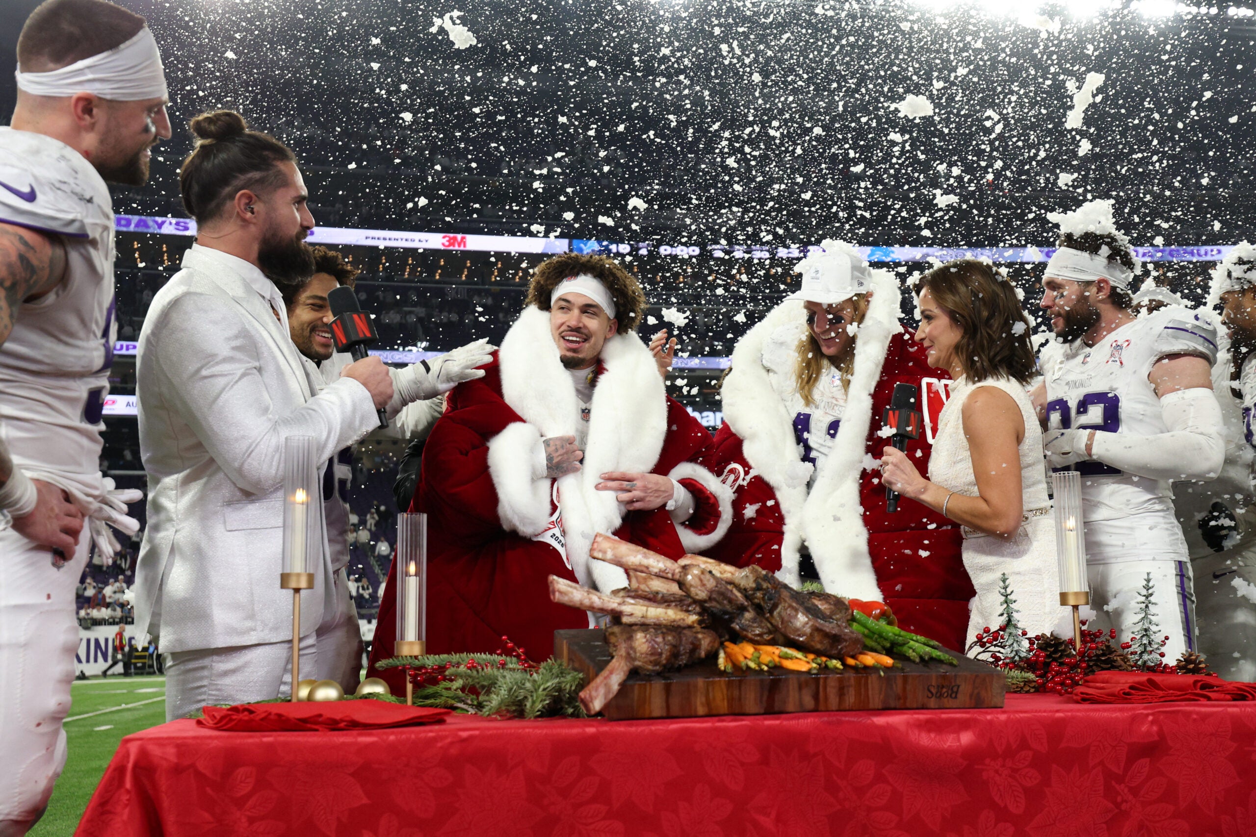 Dec 25, 2025; Minneapolis, Minnesota, USA; Minnesota Vikings cornerback Byron Murphy Jr. (7) and linebacker Andrew van Ginkel (43) are interviewed by WWE Superstar wrestler Seth Rollins and Dianna Russini after the game against the Detroit Lions at U.S. Bank Stadium.