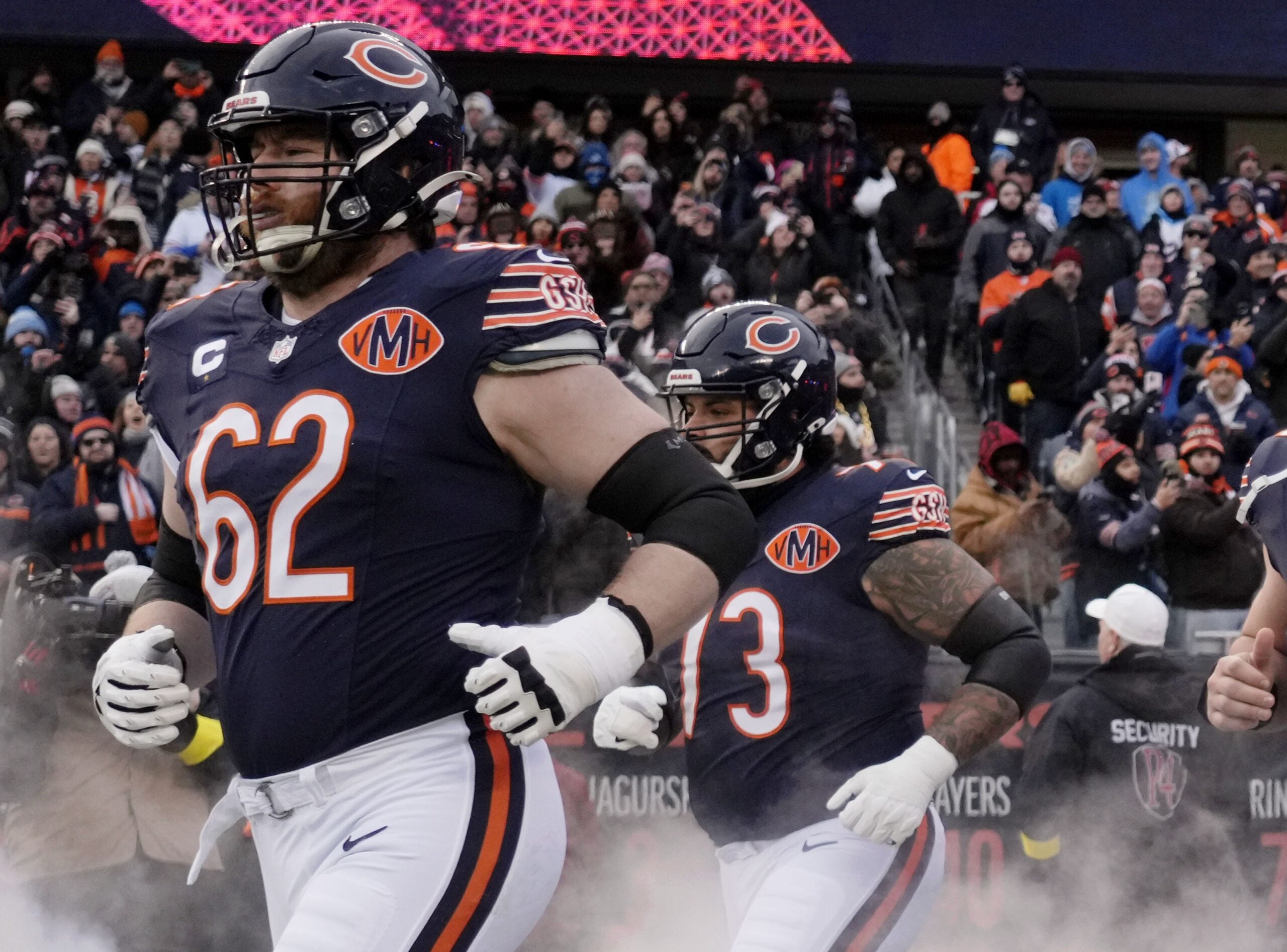 Jan 4, 2026; Chicago, Illinois, USA; Chicago Bears guard Joe Thuney (62) and Jonah Jackson (73) run onto the field before the game between the Chicago Bears and the Detroit Lions at Soldier Field.