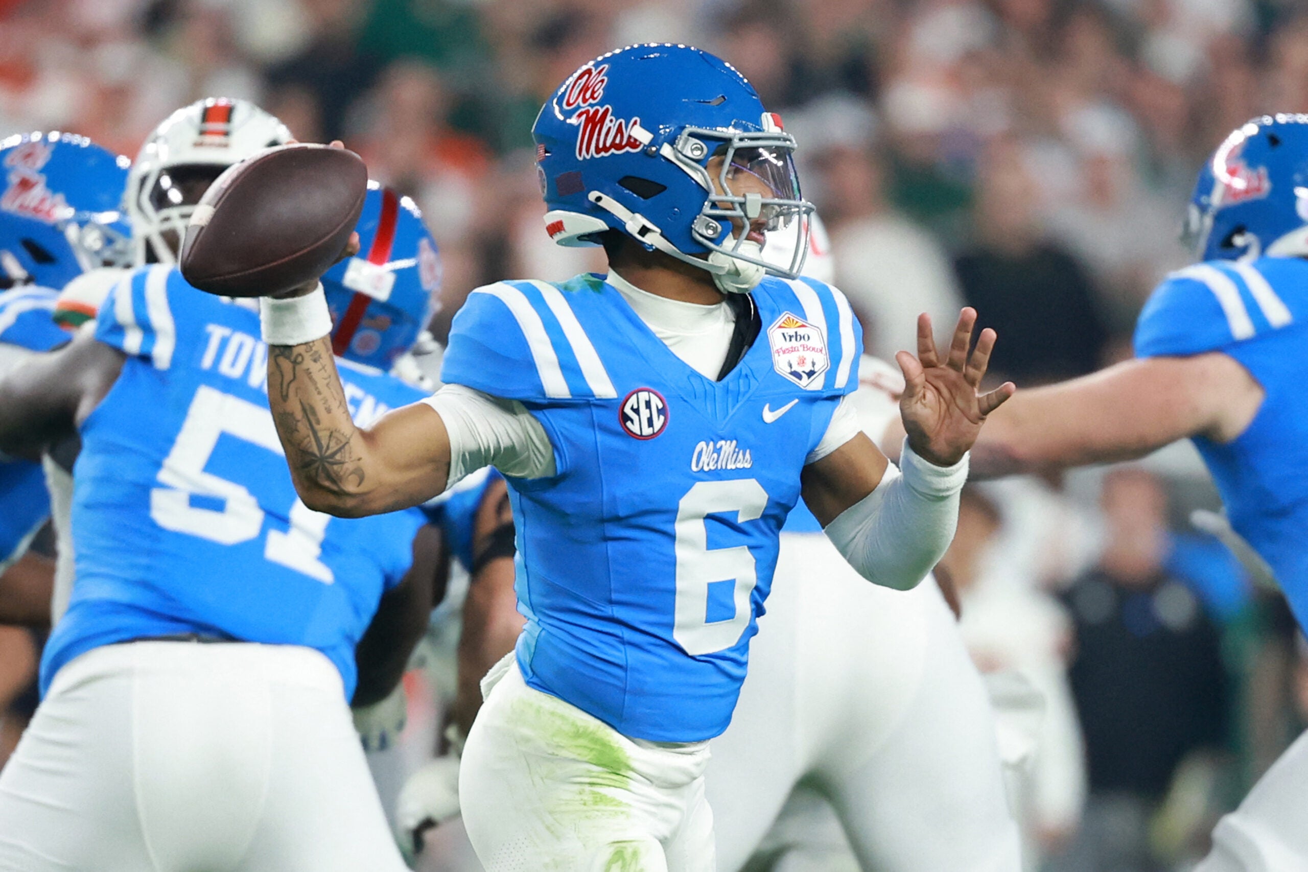 Jan 8, 2026; Glendale, AZ, USA; Mississippi Rebels quarterback Trinidad Chambliss (6) drops back to pass against the Miami Hurricanes in the first half during the 2026 Fiesta Bowl and semifinal game of the College Football Playoff at State Farm Stadium.