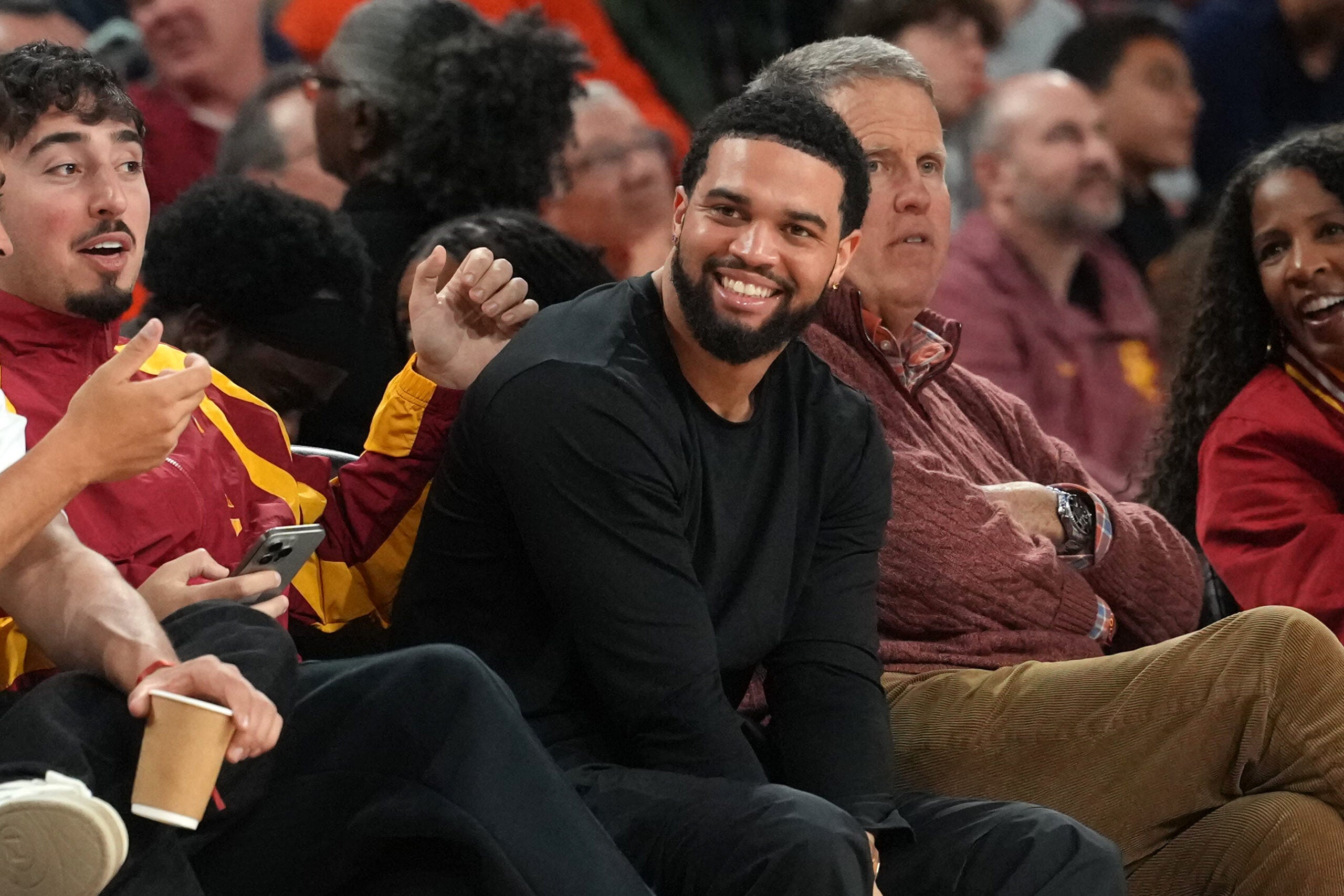Feb 18, 2026; Los Angeles, California, USA; Chicago Bears quarterback Caleb Williams watches in the second half of the game between the Illinois Fighting Illini and the Southern California Trojans at Galen Center.