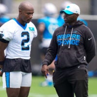 Jun 9, 2026; Charlotte, NC, USA; Carolina Panthers cornerback Mike Jackson (2) talks with defensive coach Ejiro Evero during the first day of mini camp at Bank of America Stadium practice facility.