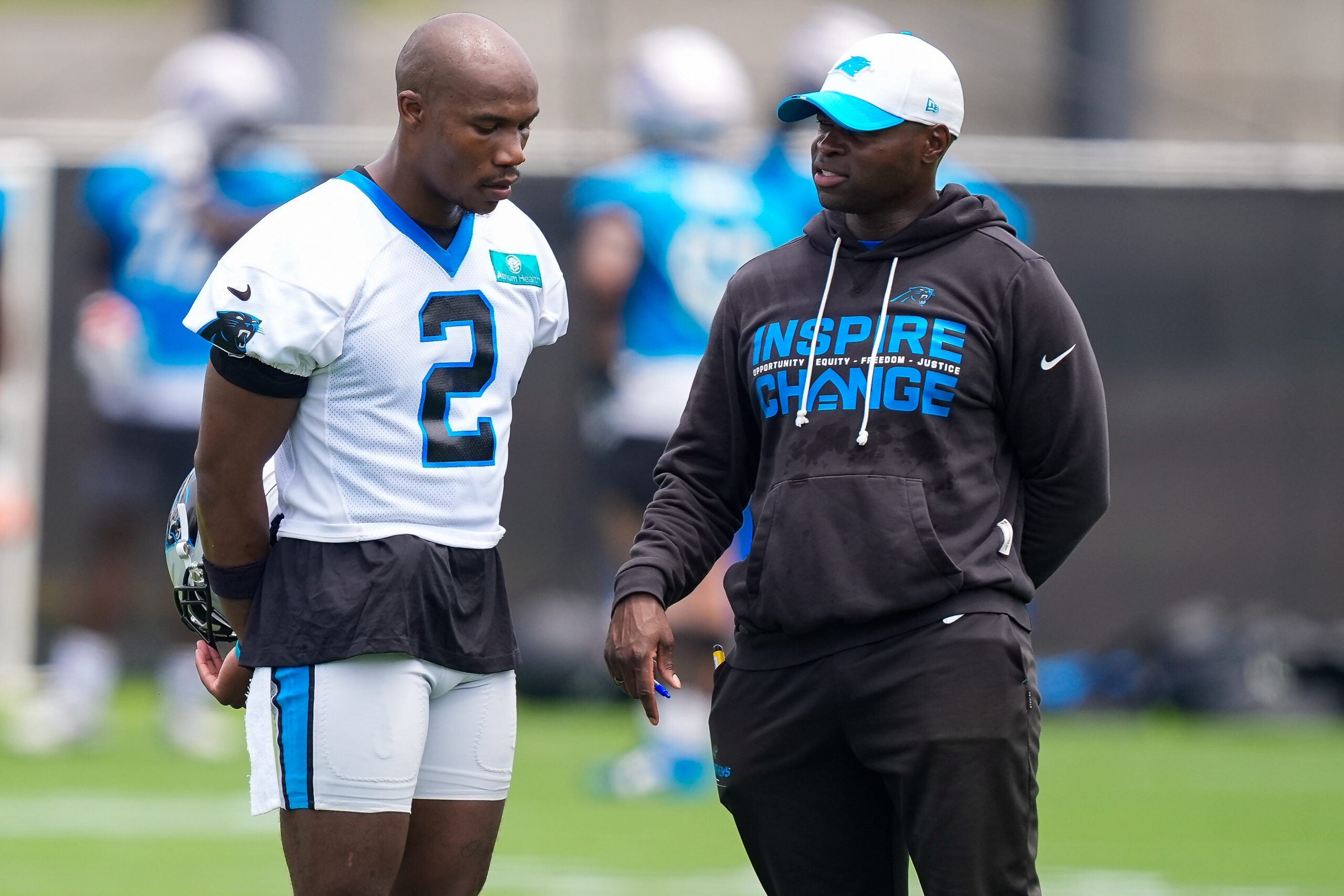 Jun 9, 2026; Charlotte, NC, USA; Carolina Panthers cornerback Mike Jackson (2) talks with defensive coach Ejiro Evero during the first day of mini camp at Bank of America Stadium practice facility.