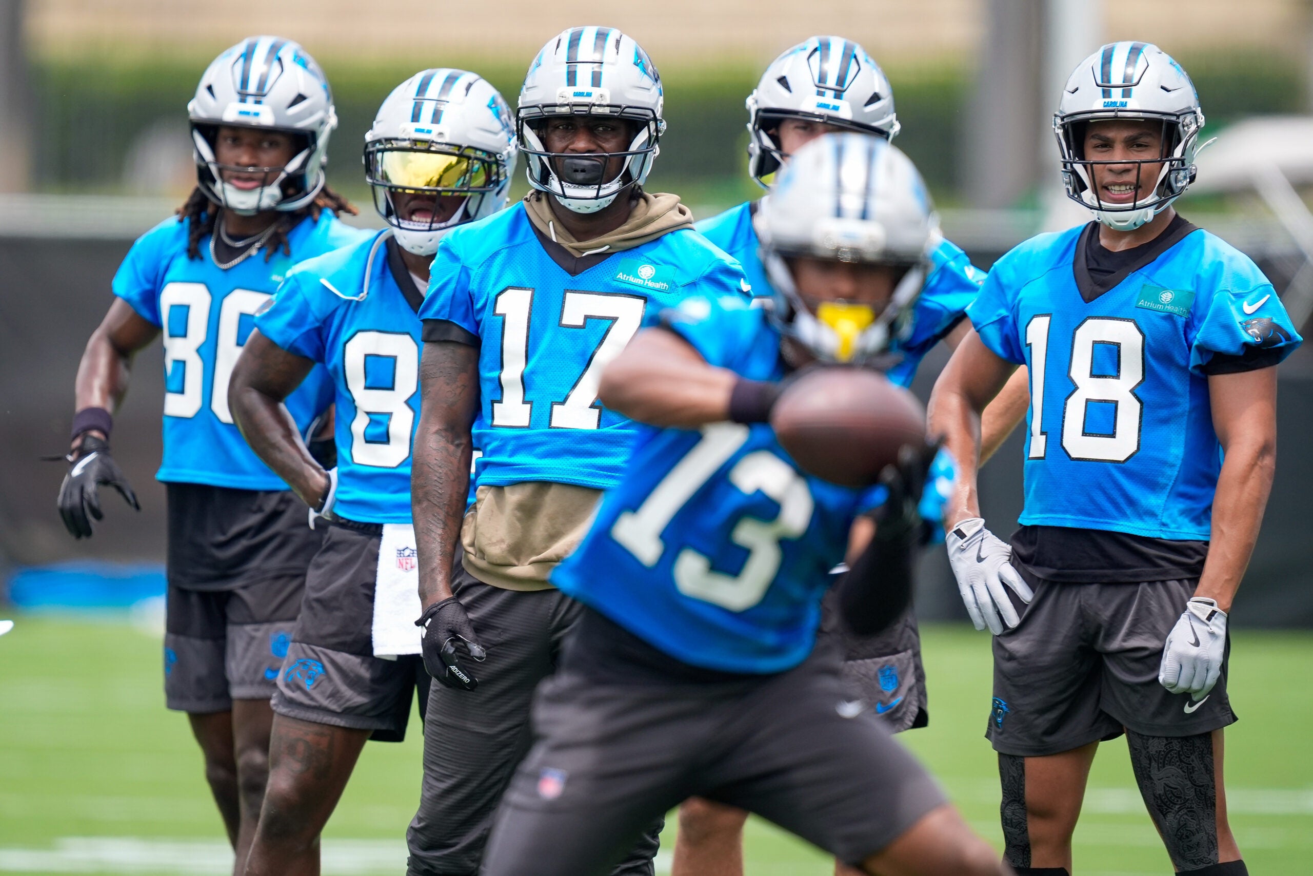 Jun 9, 2026; Charlotte, NC, USA; Wide receivers Xavier Legette, Jalen Coker, David Moore and Ja'seem Reed watch wide receiver John Metchie III (13) make a catch during the first day of mini camp at Bank of America Stadium practice facility.