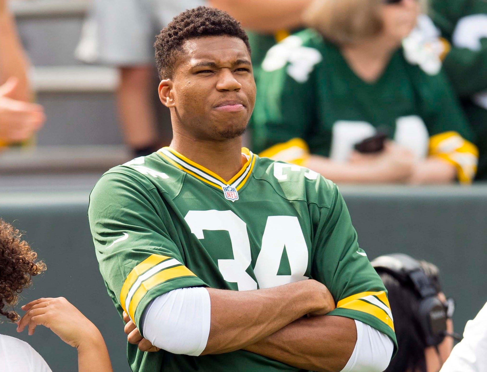 Sep 16, 2018; Green Bay, WI, USA; Milwaukee Bucks forward Giannis Antetokounmpo looks on from the sidelines during warmups priro to the game between the Minnesota Vikings and Green Bay Packers at Lambeau Field.