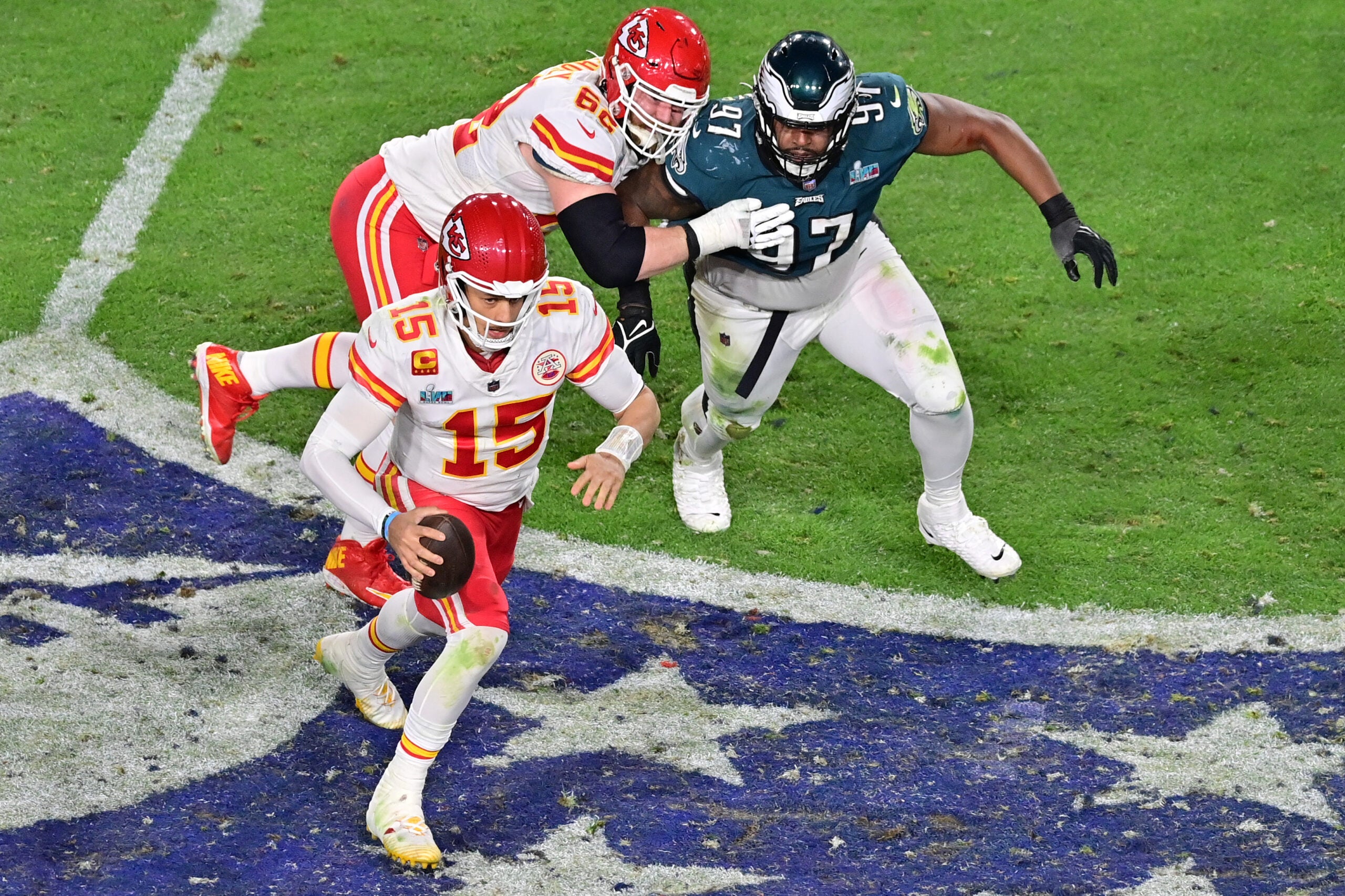 Feb 12, 2023; Glendale, Arizona, US; Kansas City Chiefs quarterback Patrick Mahomes (15) runs the ball against Philadelphia Eagles defensive tackle Javon Hargrave (97) during the fourth quarter of Super Bowl LVII at State Farm Stadium.