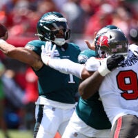 Sep 29, 2024; Tampa, Florida, USA; Philadelphia Eagles quarterback Jalen Hurts (1) is pressured by Tampa Bay Buccaneers linebacker Joe Tryon-Shoyinka (9) in the second quarter at Raymond James Stadium.
